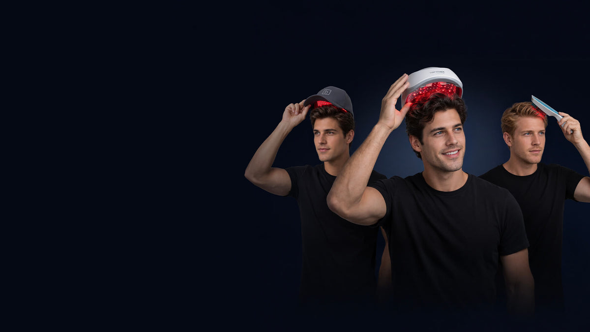 Three men wearing black t-shirts and light-colored baseball caps are shown from the waist up against a dark navy background, each holding a red light therapy device over their heads.